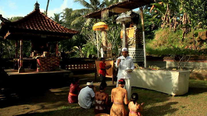 People praying and being sprinkled with water in the first temple.